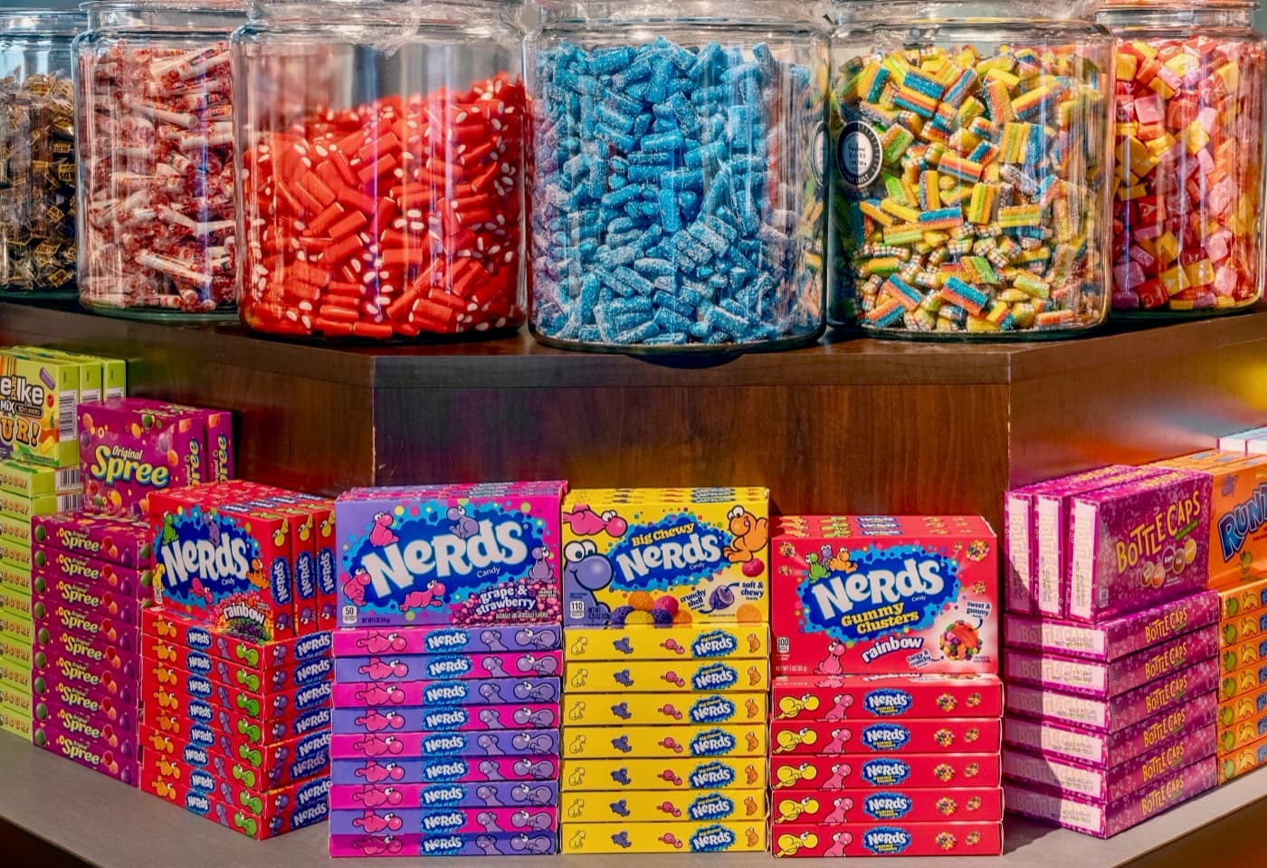 A colourful wall of Nerds and candy jars