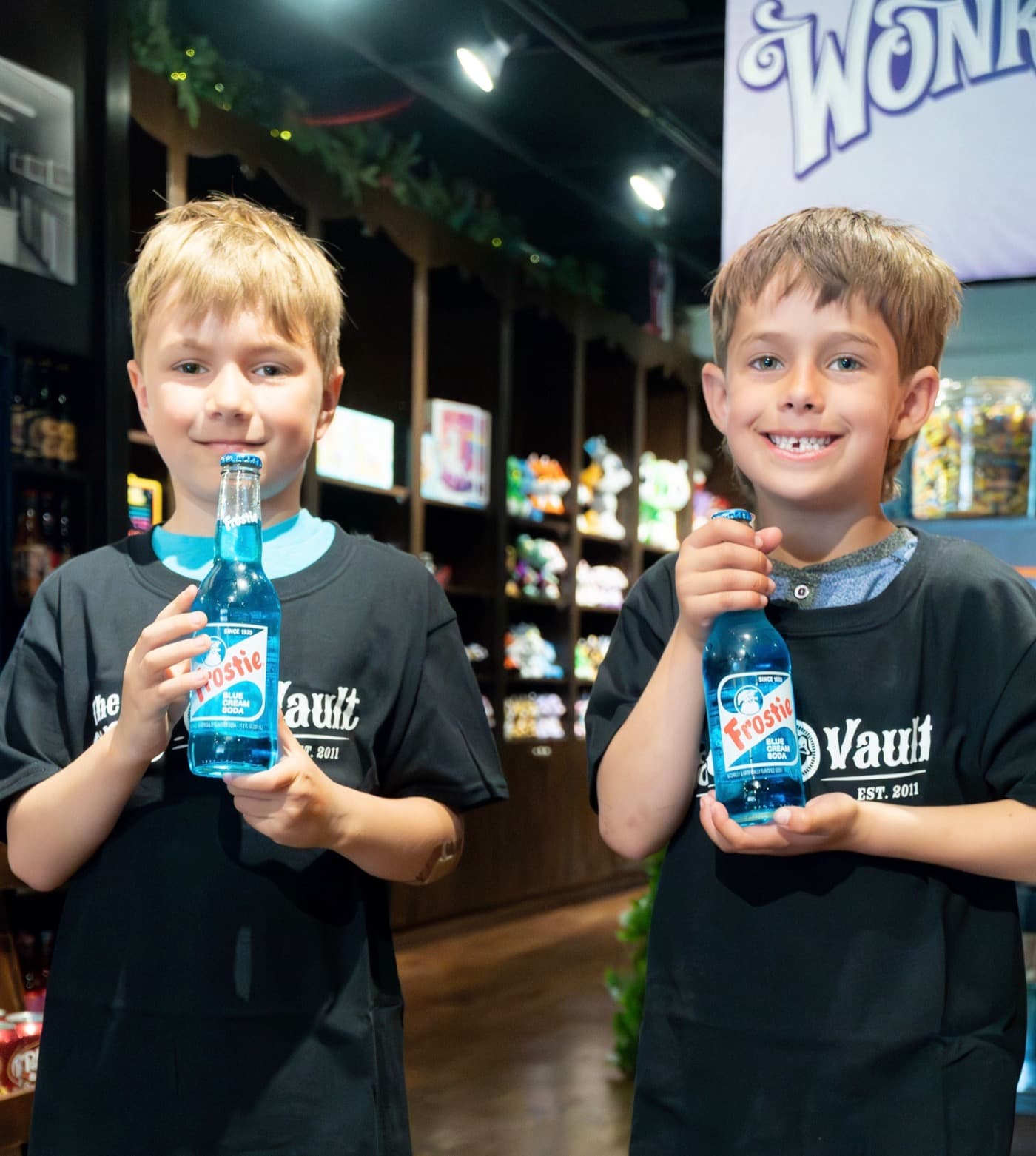 Two boys holding ice-cold Candy Vault sodas