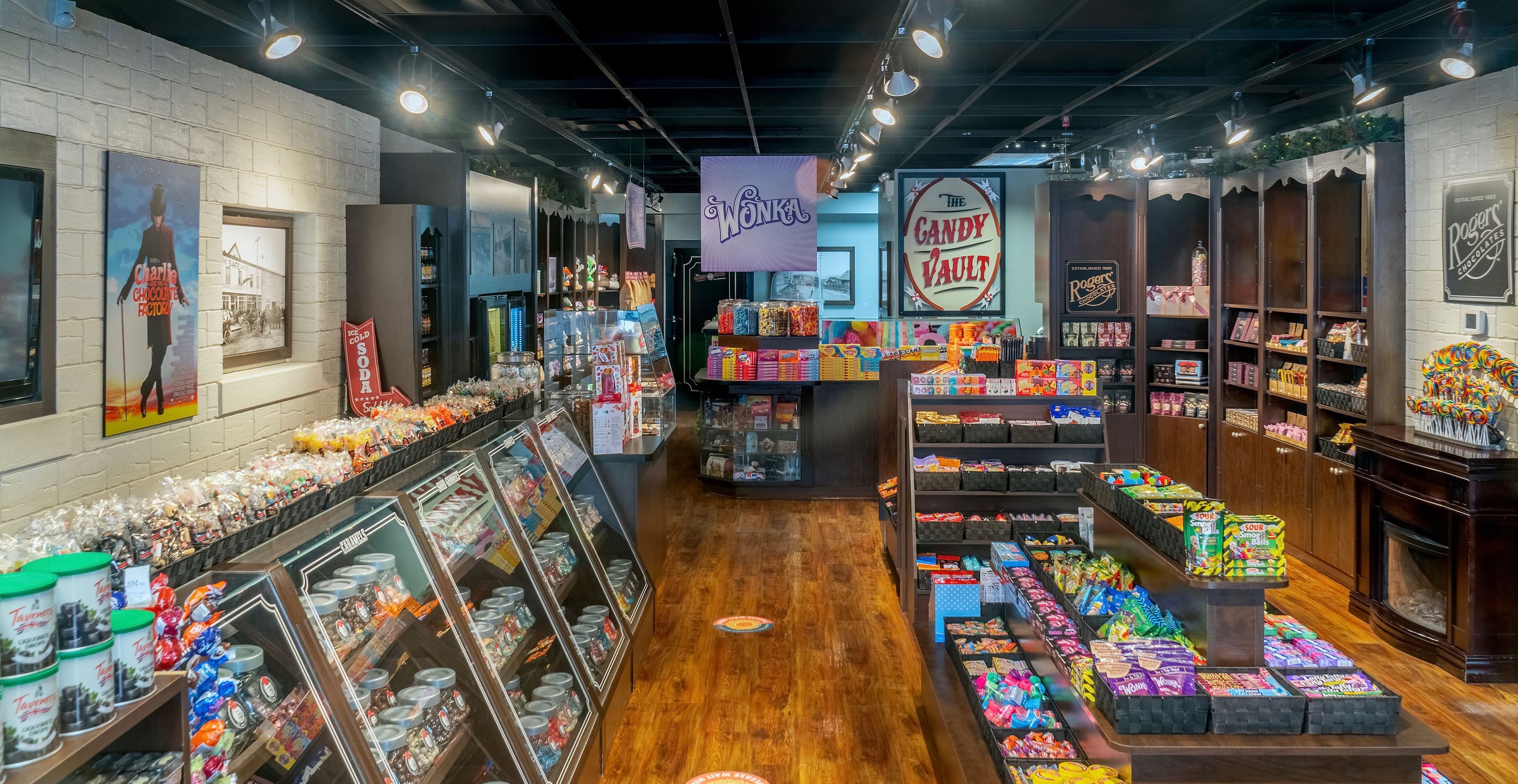 Looking down the aisle at the Candy Vault, display cases full on both sides